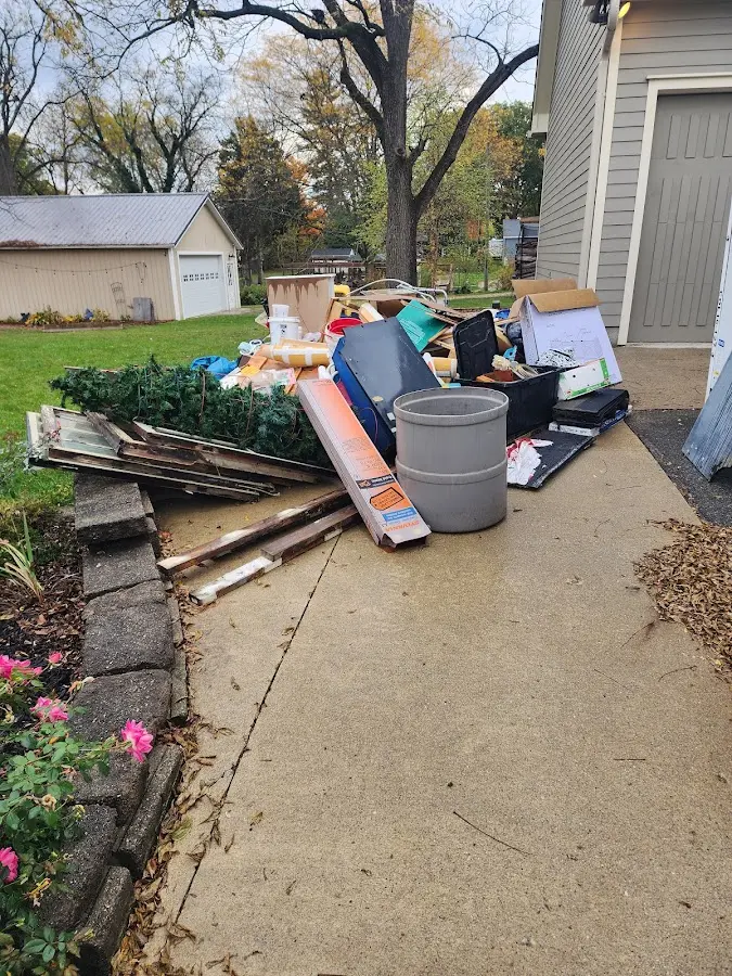 Dumpster being loaded with debris for Estate Cleanout Dumpster Rental in Westlake